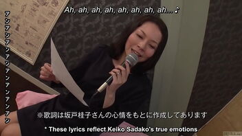 A mature Japanese woman sings provocative songs and has sex while using a karaoke machine.